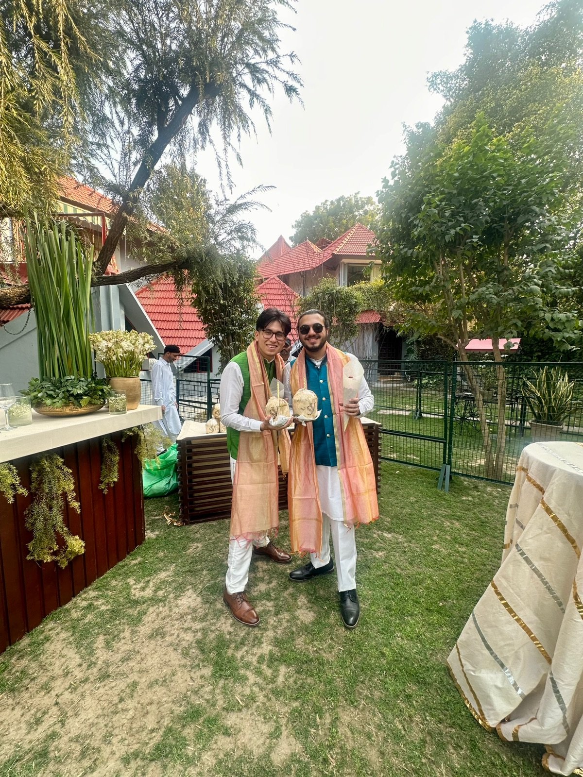 Guests holding customized coconuts at an outdoor event